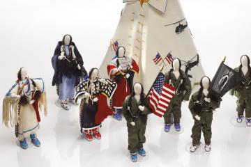 Artwork of dolls wearing traditional Oglala Lakota dresses and military uniforms next to a tipi entitled “Honoring Our Lakota Vietnam Veterans."