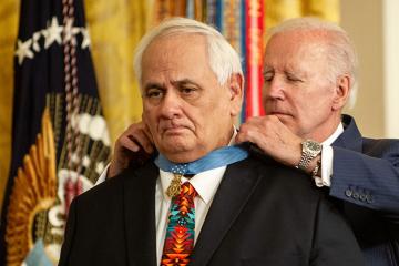 President Biden places the Medal of Honor around the neck of veteran Dwight Birdwell