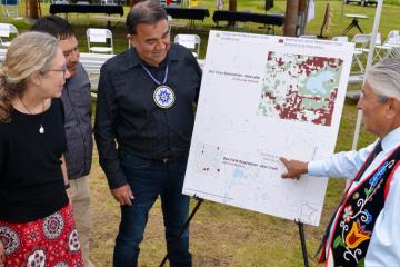 A council member points to a map of recently purchased lands.