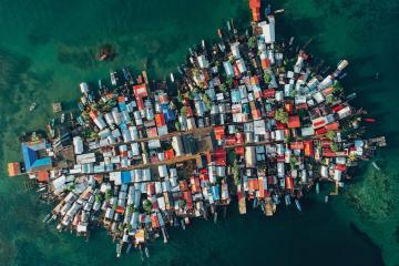An aerial view of a small island completely covered with colorful buildings