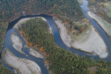 Aerial view of a river winding through a green landscape