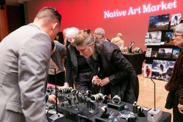 People look at the art pieces at the Native Art Market.